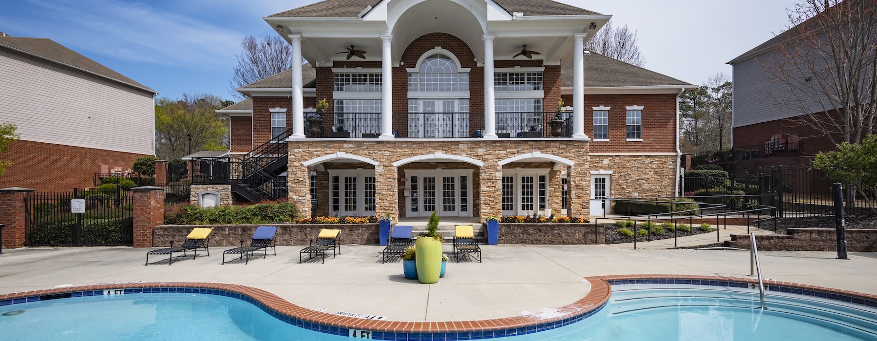 a large building with a pool in front of it